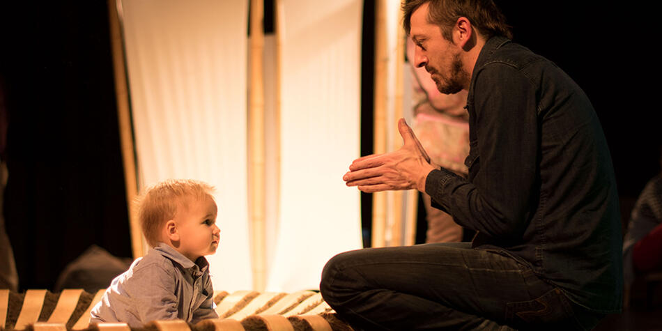 Photo of the host in front of a toddler
